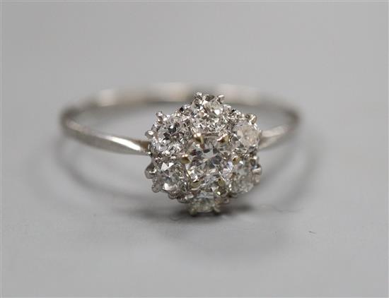 A white metal and seven stone diamond cluster ring, size U.